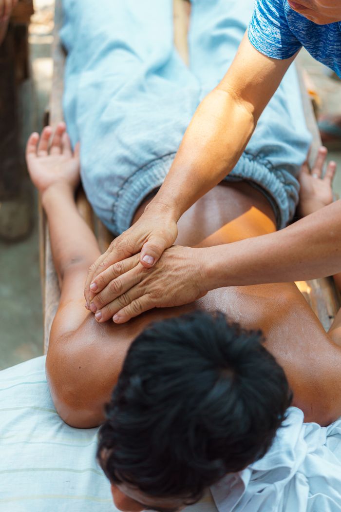 A soothing massage therapy session taking place outdoors, focusing on relaxation and wellness.