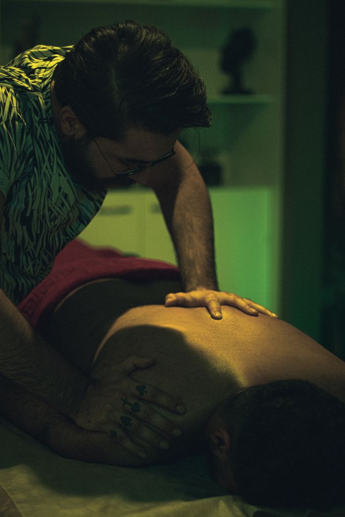 A soothing back massage in a dimly lit room ensuring relaxation.